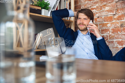 Image of Young man, manager, team led return to work in his office after quarantine, feels happy and inspired