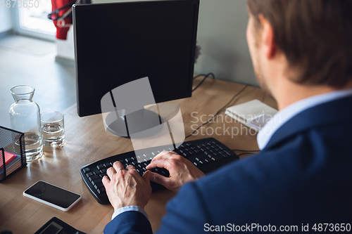 Image of Young man, manager, team led return to work in his office after quarantine, feels happy and inspired