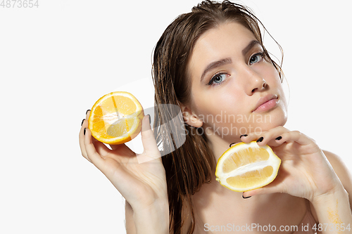 Image of Youth secrets. Close up of beautiful young woman with lemon and orange slices over white background. Cosmetics and makeup, natural and eco treatment, skin care.