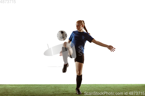 Image of Female soccer, football player kicking ball, training in action and motion with bright emotions isolated on white background