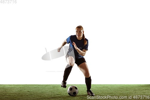 Image of Female soccer, football player kicking ball, training in action and motion with bright emotions isolated on white background