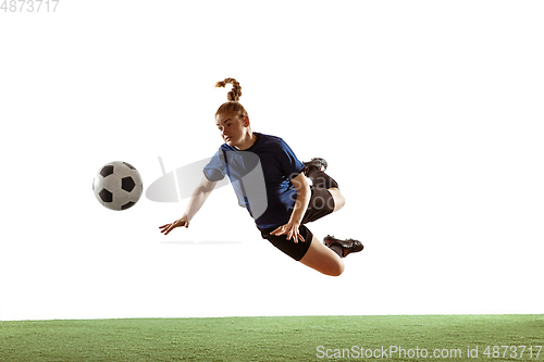 Image of Female soccer, football player kicking ball, training in action and motion with bright emotions isolated on white background