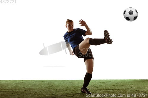 Image of Female soccer, football player kicking ball, training in action and motion with bright emotions isolated on white background