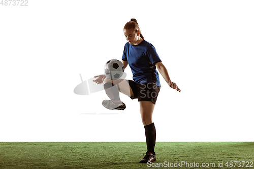 Image of Female soccer, football player kicking ball, training in action and motion with bright emotions isolated on white background