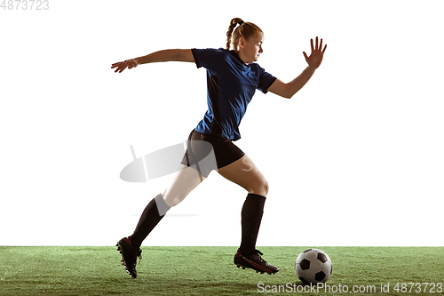 Image of Female soccer, football player kicking ball, training in action and motion with bright emotions isolated on white background