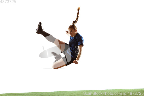 Image of Female soccer, football player kicking ball, training in action and motion with bright emotions isolated on white background