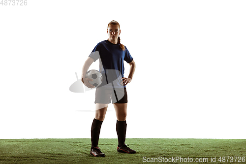 Image of Female soccer, football player posing confident with ball isolated on white background