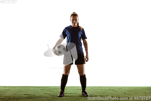 Image of Female soccer, football player posing confident with ball isolated on white background
