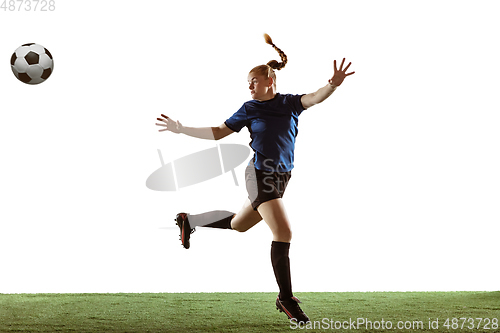 Image of Female soccer, football player kicking ball, training in action and motion with bright emotions isolated on white background