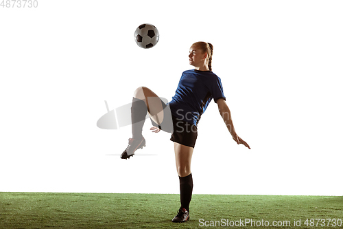 Image of Female soccer, football player kicking ball, training in action and motion with bright emotions isolated on white background