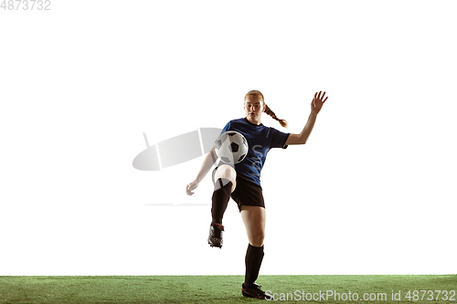 Image of Female soccer, football player kicking ball, training in action and motion with bright emotions isolated on white background