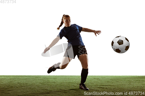Image of Female soccer, football player kicking ball, training in action and motion with bright emotions isolated on white background