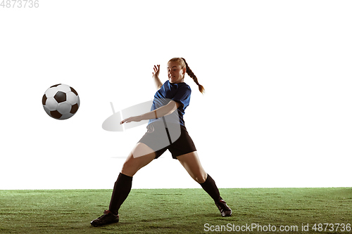 Image of Female soccer, football player kicking ball, training in action and motion with bright emotions isolated on white background