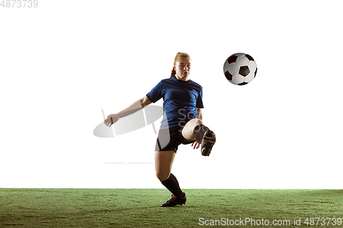 Image of Female soccer, football player kicking ball, training in action and motion with bright emotions isolated on white background