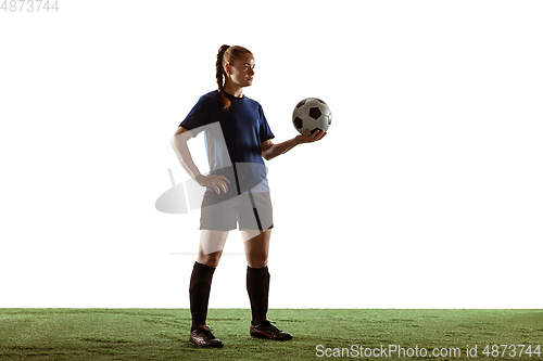 Image of Female soccer, football player posing confident with ball isolated on white background