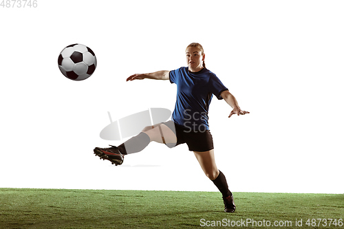 Image of Female soccer, football player kicking ball, training in action and motion with bright emotions isolated on white background