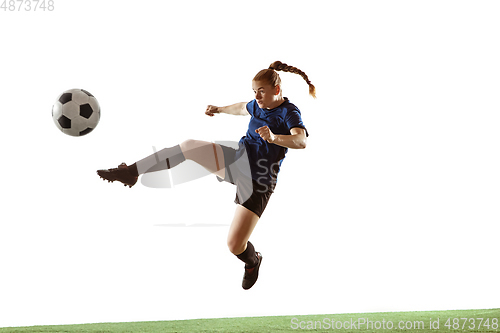 Image of Female soccer, football player kicking ball, training in action and motion with bright emotions isolated on white background