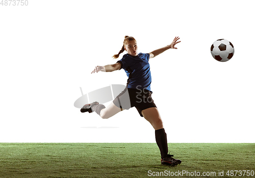 Image of Female soccer, football player kicking ball, training in action and motion with bright emotions isolated on white background