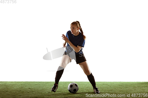 Image of Female soccer, football player kicking ball, training in action and motion with bright emotions isolated on white background