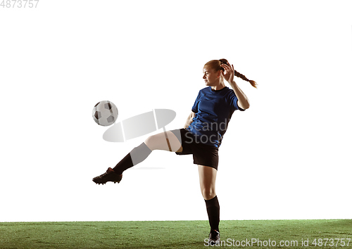 Image of Female soccer, football player kicking ball, training in action and motion with bright emotions isolated on white background