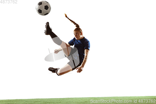 Image of Female soccer, football player kicking ball, training in action and motion with bright emotions isolated on white background