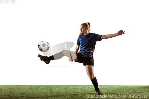 Image of Female soccer, football player kicking ball, training in action and motion with bright emotions isolated on white background