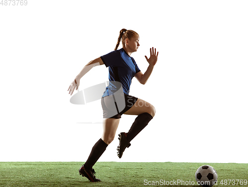 Image of Female soccer, football player kicking ball, training in action and motion with bright emotions isolated on white background