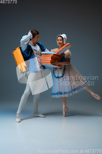 Image of Young and graceful ballet dancers as Cinderella fairytail characters hurrying up with pizza like deliveryman