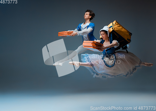 Image of Young and graceful ballet dancers as Cinderella fairytail characters hurrying up with pizza like deliveryman