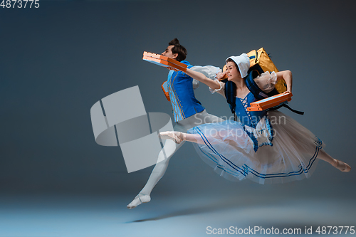 Image of Young and graceful ballet dancers as Cinderella fairytail characters hurrying up with pizza like deliveryman