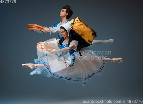 Image of Young and graceful ballet dancers as Cinderella fairytail characters hurrying up with pizza like deliveryman