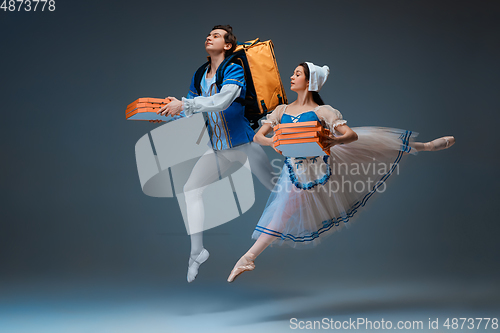 Image of Young and graceful ballet dancers as Cinderella fairytail characters hurrying up with pizza like deliveryman
