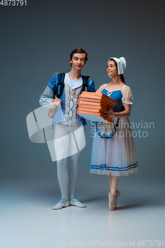 Image of Young and graceful ballet dancers as Cinderella fairytail characters hurrying up with pizza like deliveryman