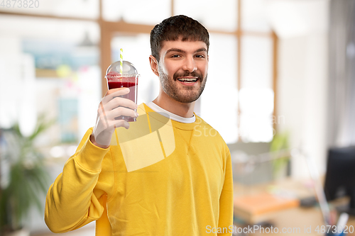 Image of happy man with juice in plastic cup at office