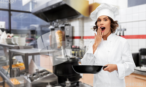 Image of surprised chef with frying pan at kebab shop
