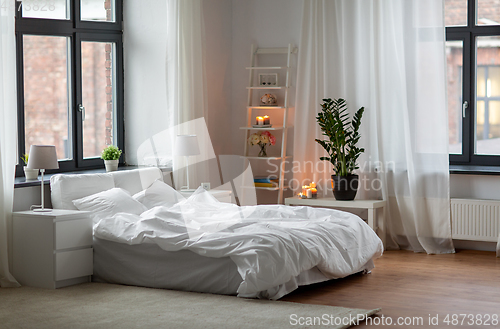 Image of cozy bedroom with white linen on bed