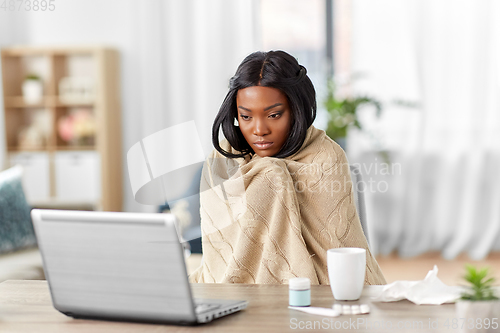 Image of sick woman having video call on laptop at home