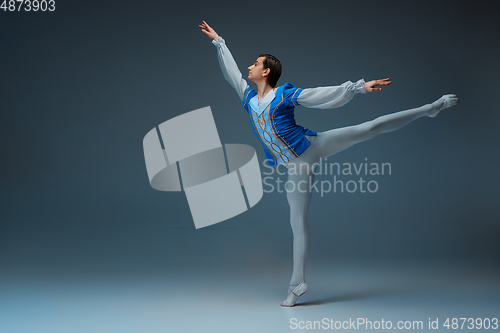 Image of Young and graceful ballet dancer in action isolated on studio background