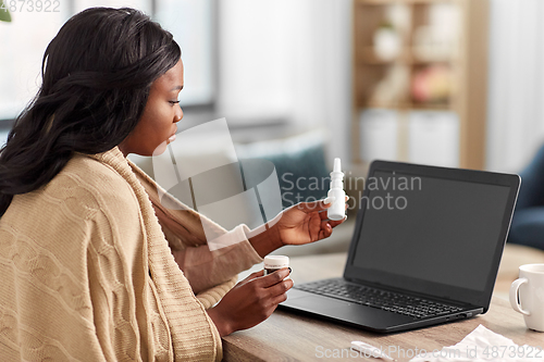 Image of sick woman having video call on laptop at home