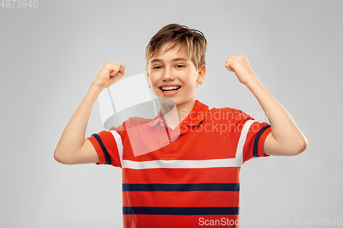 Image of portrait of happy smiling boy celebrating success