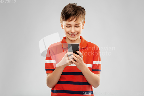 Image of portrait of happy smiling boy with smartphone