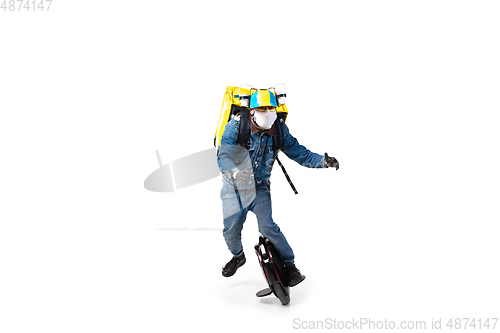 Image of Too much orders. Contacless delivery service during quarantine. Man delivers food and shopping bags during isolation, wearing gloves and face mask.