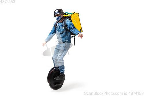 Image of Too much orders. Contacless delivery service during quarantine. Man delivers food and shopping bags during isolation, wearing gloves and face mask.