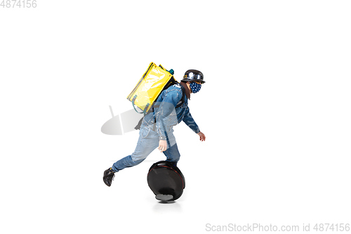 Image of Too much orders. Contacless delivery service during quarantine. Man delivers food and shopping bags during isolation, wearing gloves and face mask.