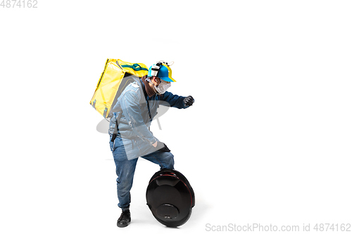 Image of Too much orders. Contacless delivery service during quarantine. Man delivers food and shopping bags during isolation, wearing gloves and face mask.