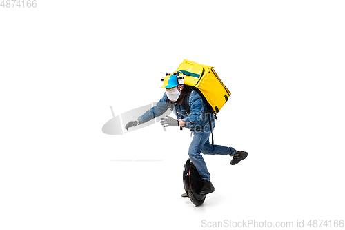 Image of Too much orders. Contacless delivery service during quarantine. Man delivers food and shopping bags during isolation, wearing gloves and face mask.