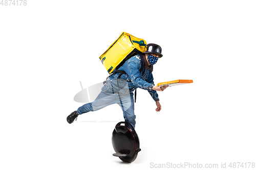 Image of Too much orders. Contacless delivery service during quarantine. Man delivers food and shopping bags during isolation, wearing gloves and face mask.