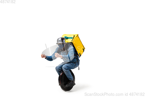 Image of Too much orders. Contacless delivery service during quarantine. Man delivers food and shopping bags during isolation, wearing gloves and face mask.