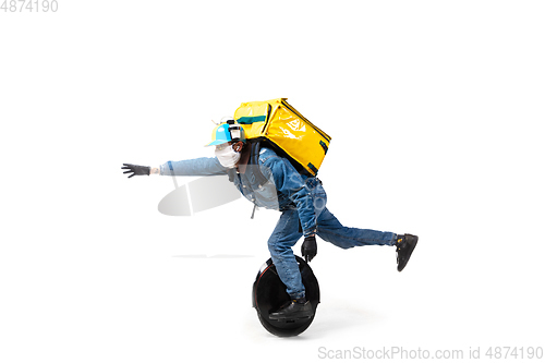 Image of Too much orders. Contacless delivery service during quarantine. Man delivers food and shopping bags during isolation, wearing gloves and face mask.