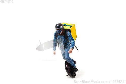 Image of Too much orders. Contacless delivery service during quarantine. Man delivers food and shopping bags during isolation, wearing gloves and face mask.